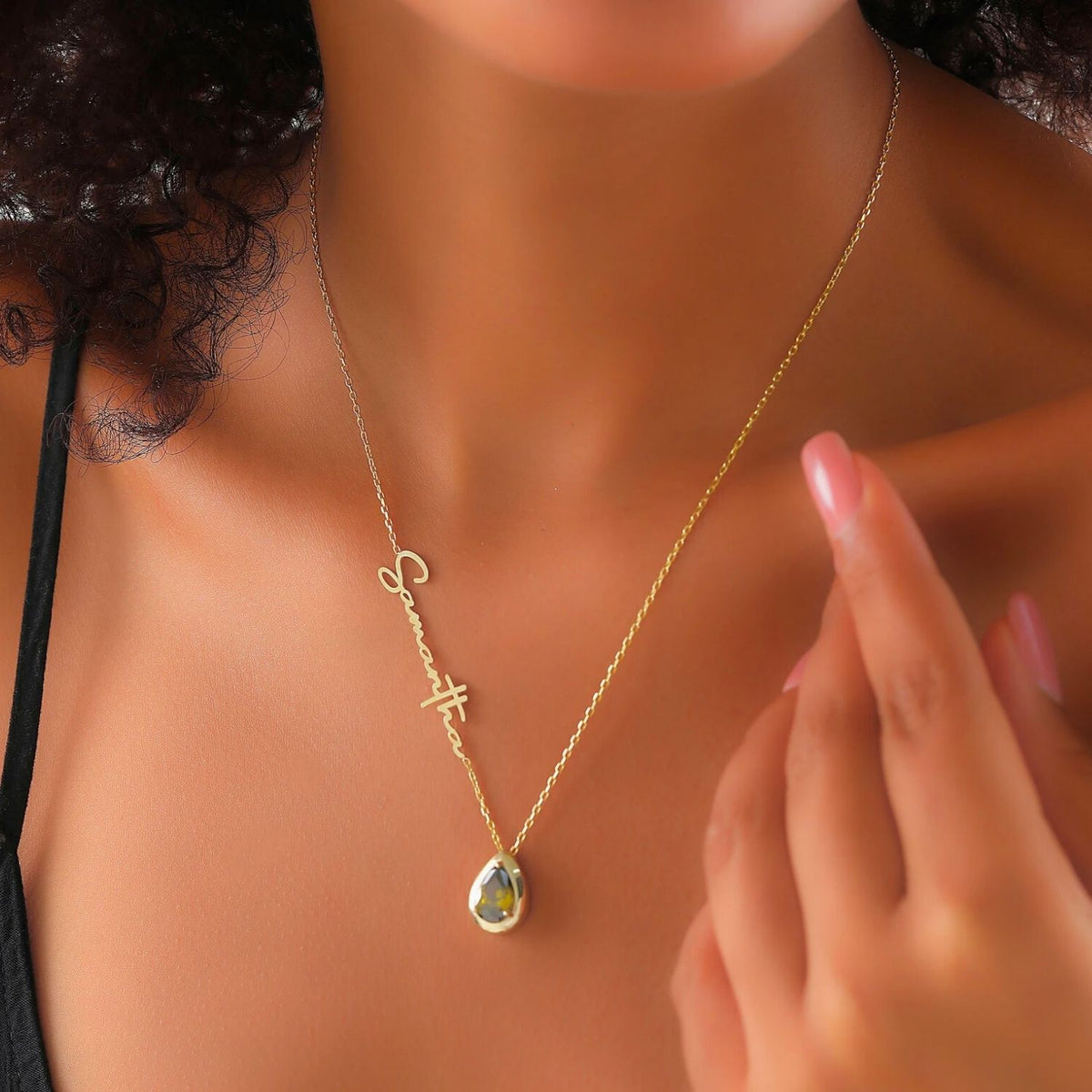 Gold necklace with a peridot pendant on a woman's neck