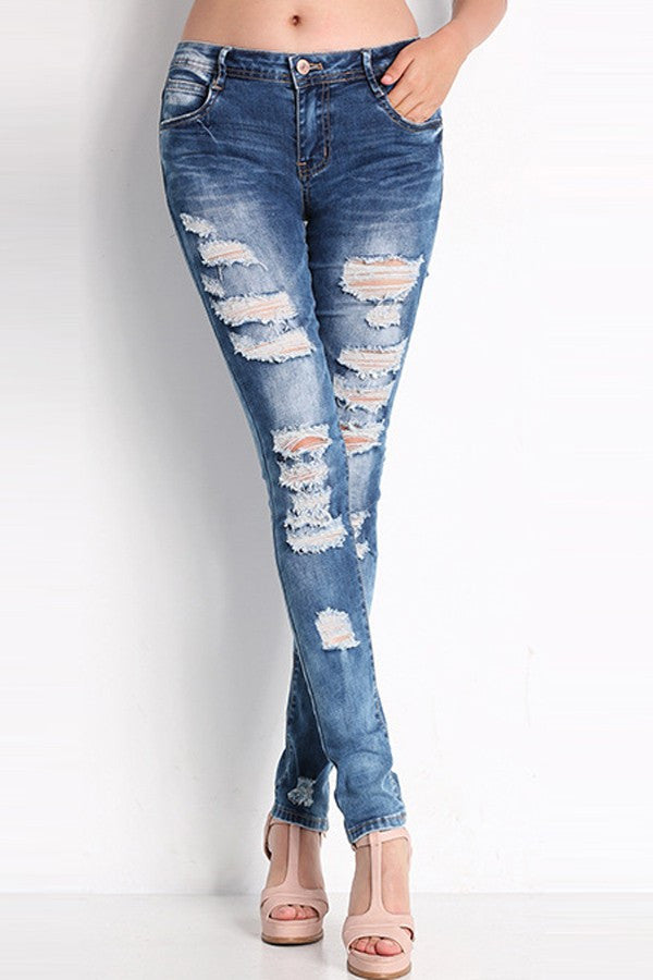 A pair of medium wash, distressed skinny leg blue jeans with a 5 pocket design.