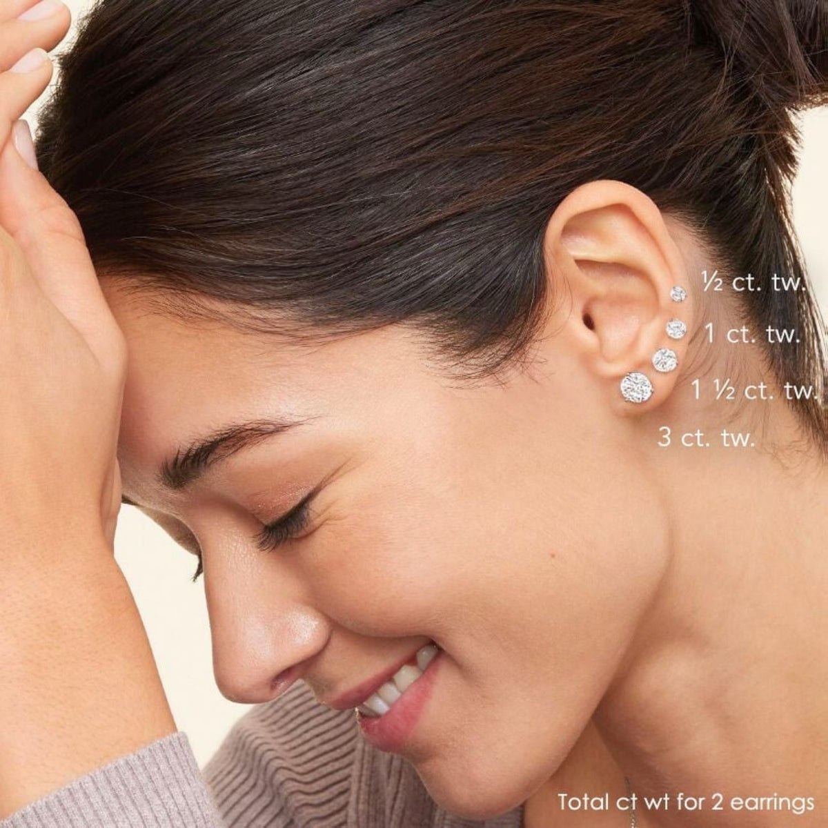 Woman wearing diamond stud earrings with diamond carat size options displayed next to her ear.