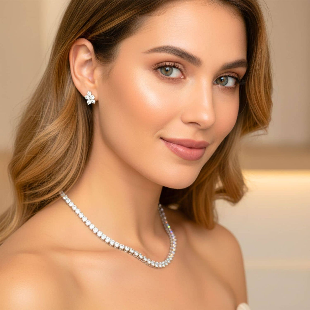 Woman wearing a diamond tennis necklace and matching earrings with a neutral background