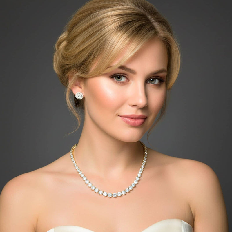 Woman wearing a diamond tennis necklace and diamond earrings against a gray background
